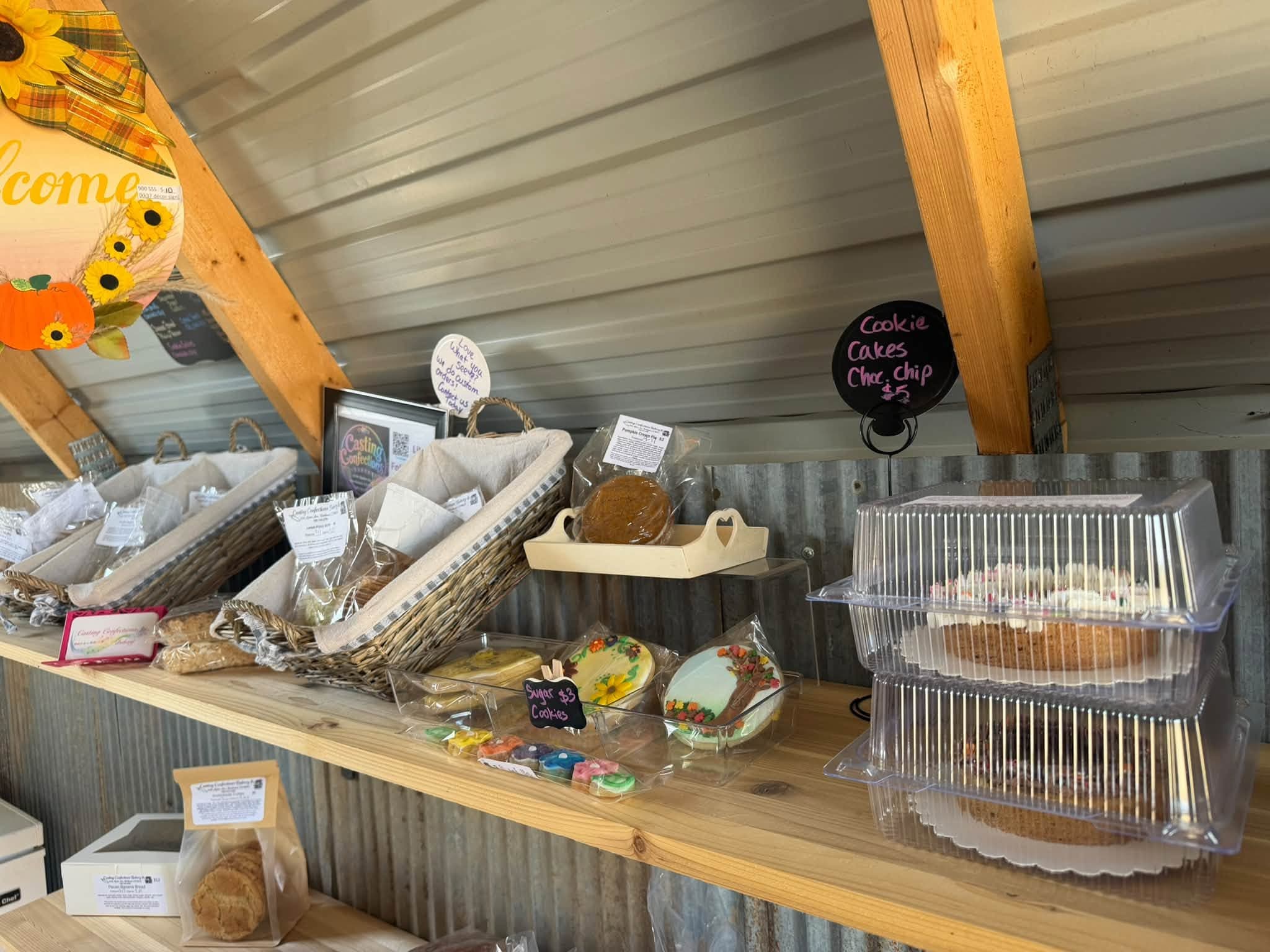 Counter displaying fresh eggs, baked goods, cookies, and cakes